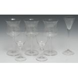 A set of three wine glasses, waisted bowls engraved with fruiting vine, cotton twist stems,