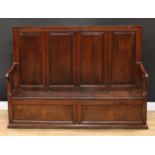 An 18th century oak box settle, rectangular back with four raised and fielded panel, downswept arms,