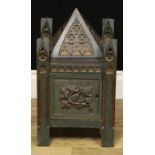 A Gothic Revival polychrome painted oak table cabinet, carved throughout with blind tracery and