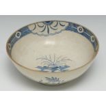 A Worcester bowl, decorated in underglazed blue with stylised roks and scrolling foliage, the