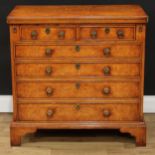 A Queen Anne/George I style walnut bachelor's chest, hinged fold-over rectangular top above two