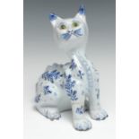 A 19th century Delft cat, painted in blue with stylised foliage, green glass eyes, 21cm high, late