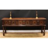 A Charles II design oak block front low dresser, oversailing plank top with moulded edge above three