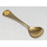 Georg Jensen - a Danish silver-gilt and enamel spoon, decorated with a yellow rose, 15cm long,