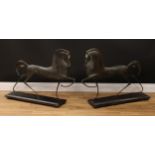 In the manner of Boris Lovet-Lorski (1894 - 1973), a pair of bronzes, Etruscan Horses, slate