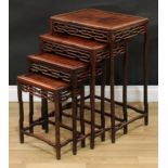 A set of Chinese hardwood quartetto tables, each with a rectangular panel top, shaped aprons, ruyi