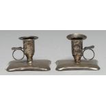 A pair of 19th century Russian silver chamber sticks, bell shaped sconces, the incurved rounded