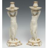 A pair of Royal Worcester glazed parian figural candlesticks, of young ladies holding sconces