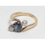 A diamond and sapphire twist ring, central old cut mixed tone blue sapphire, approx 0.75ct,