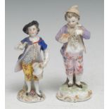 A 19th century German porcelain figure, of a young boy, in the Rococo taste, pierced C-scroll