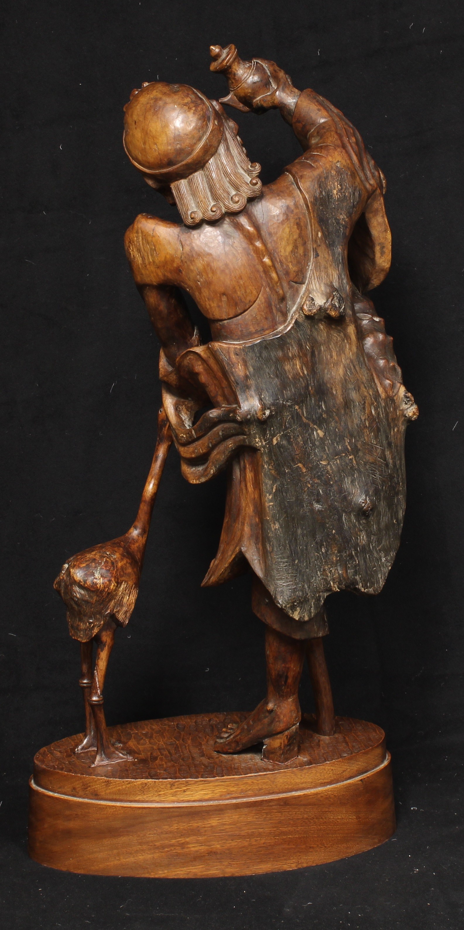 A large Japanese rootwood figure, carved as an emaciated elder beside a crane, oval base, 82cm high, - Image 4 of 4