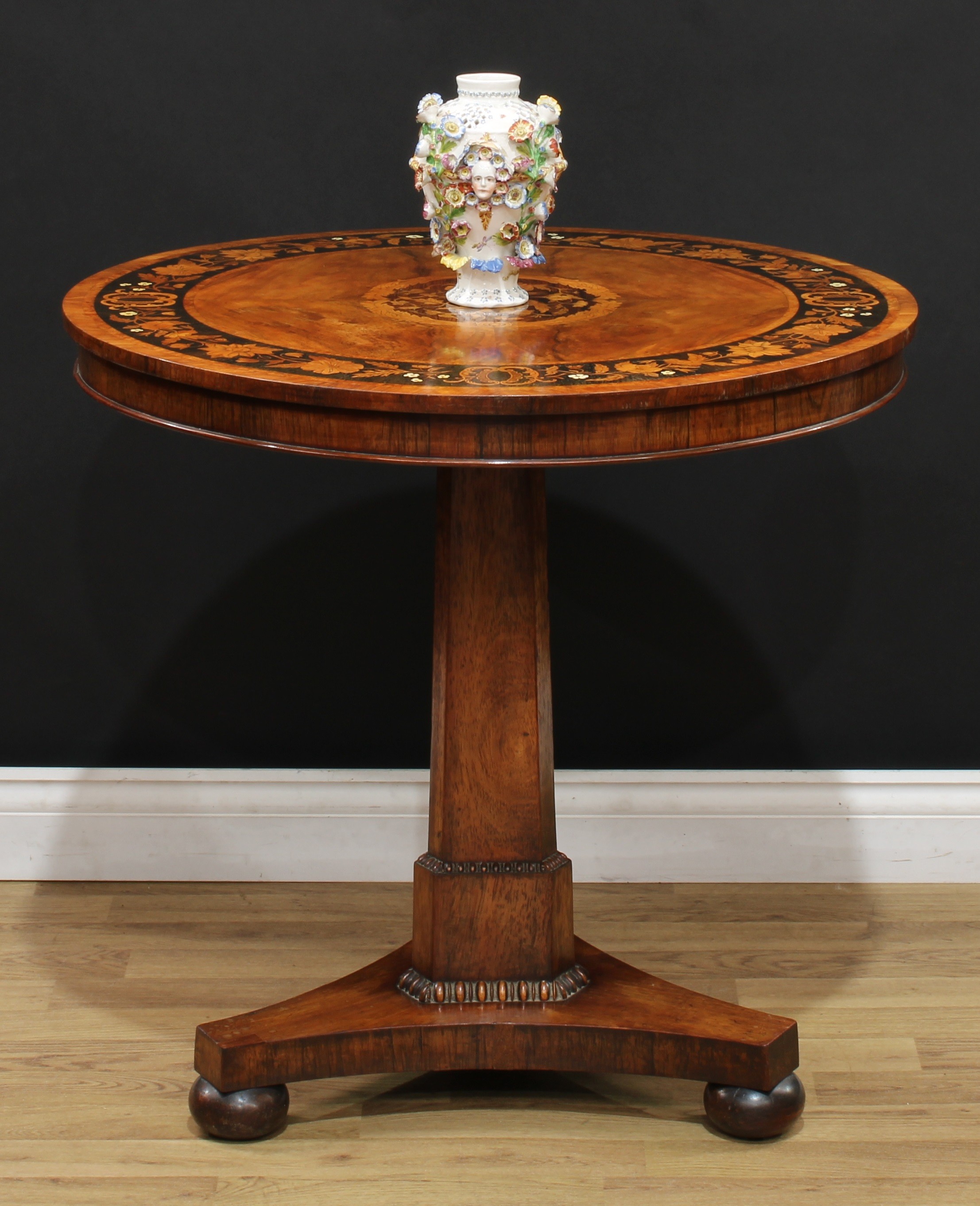 A William IV walnut, rosewood and marquetry centre table, circular tilting top inlaid with a bird