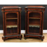 A pair of Victorian gilt metal mounted amboyna and ebonised music room pier cabinets, each with a