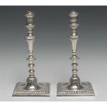 A pair of George III cast silver table candlesticks, knopped pillars, dished square bases, gadrooned