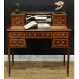 An Edwardian mahogany writing table, of bonheur du jour proportions, the inverted break-centre