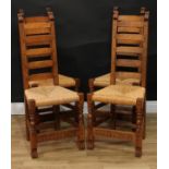A set of four Rupert Griffiths Monastic Woodcraft oak ladder back dining chairs, rush seats,