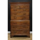 A George III oak chest on chest, outswept rectangular top with blind fretwork frieze above two short