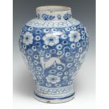 An 18th century Delft ovoid jar, tin glazed in the Chinese taste with dragons on a ground of