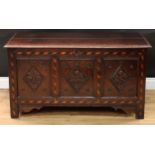 An early 18th century oak blanket chest, hinged top enclosing a till, above a three panel front,