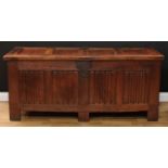 A substantial 18th century oak blanket chest, hinged four panel top enclosing a till, the front