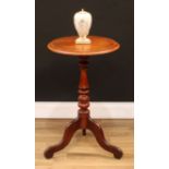 An early Victorian mahogany tripod wine table, circular top with moulded edge, turned pillar, shaped