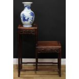 A Chinese hardwood two-tier vase table, with an asymmetrical arrangement of panel plateaux, each