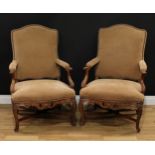 A pair of Louis XV French walnut armchairs, cartouche shaped backs with serpentine crestings, shaped