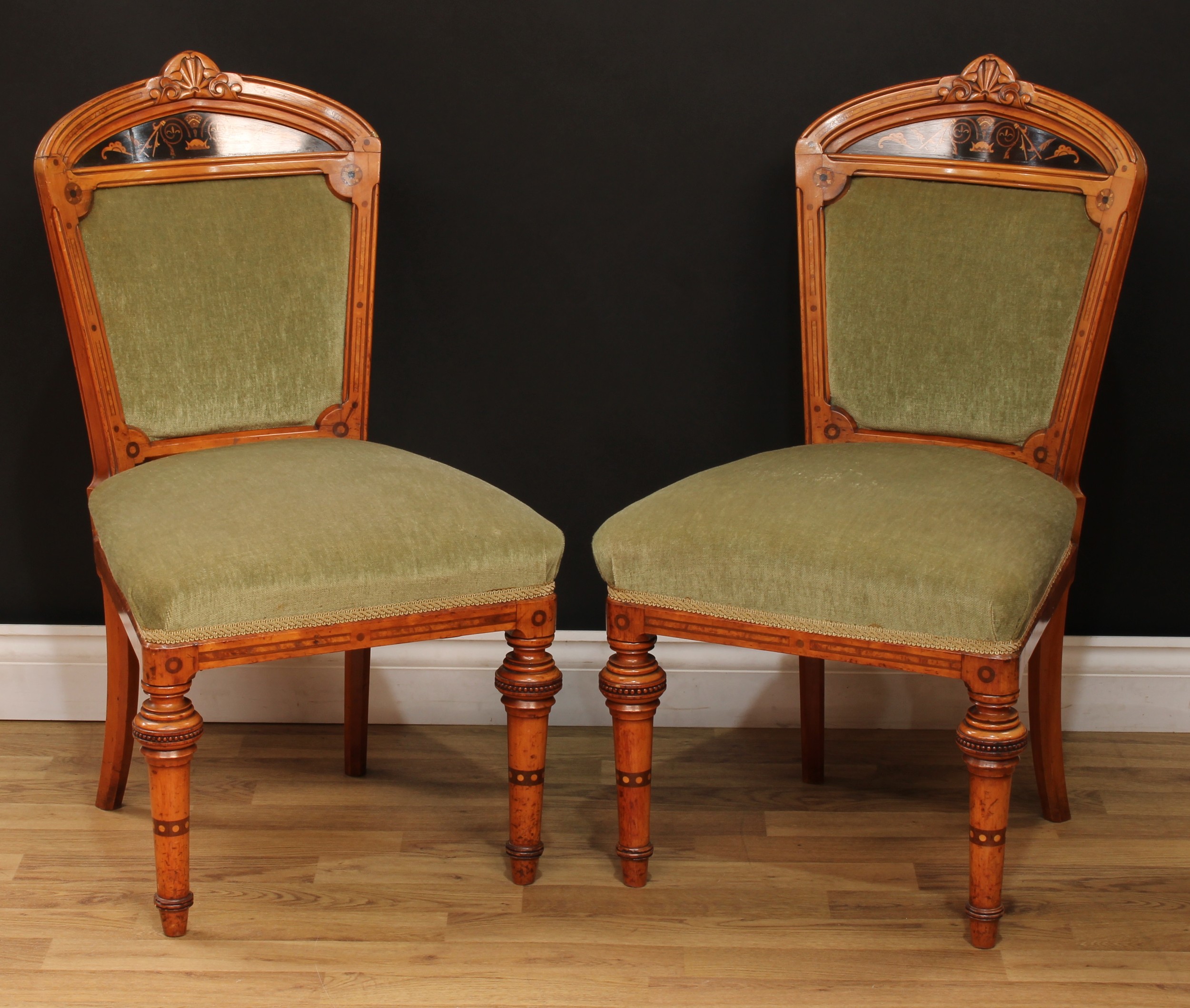 A pair of Victorian walnut and marquetry side chairs, each with shaped cresting rail carved with a