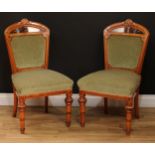 A pair of Victorian walnut and marquetry side chairs, each with shaped cresting rail carved with a