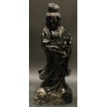 A large Chinese hardstone figure, carved as Guanyin holding a ruyi sceptre and a pearl, 94cm high
