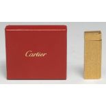 A Cartier gold plated cigarette lighter, bark-textured finish, 7cm long, no.1D17761, boxed