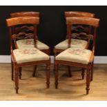 A set of four William IV mahogany dining chairs, each with a curved cresting rail above a shaped and