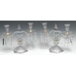 A pair of 19th century glass two-light candle lustres, fluted campana sconces, shaped drip pans,