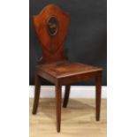 A George III mahogany Heraldic hall chair, shield shaped back with painted oval reserve, panel seat,