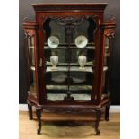 A late Victorian mahogany display cabinet, rectangular top with acanthus capital above a glazed door