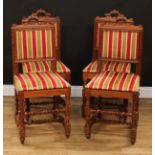 A set of four Cromwellian Revival oak dining chairs, each with a rectangular back with architectural