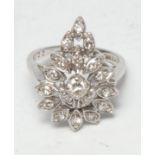 An Art Deco diamond cluster ring, the pear shaped fan crest inset with eighteen old brilliant cut