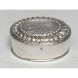 An early 18th century German silver oval spice or snuff box push-fitting cover chased with scrolling