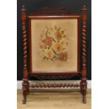 A Victorian walnut and mahogany firescreen, rectangular banner worked in wool with flowers and