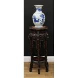 A 19th century Chinese hardwood vase or jardiniere stand, shaped circular top with inset soapstone