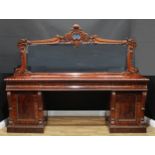 A substantial early Victorian flame mahogany sideboard, the mirror back with lofty cresting boldly
