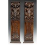 A pair of Baroque oak pilasters, carved as herms, 57cm long