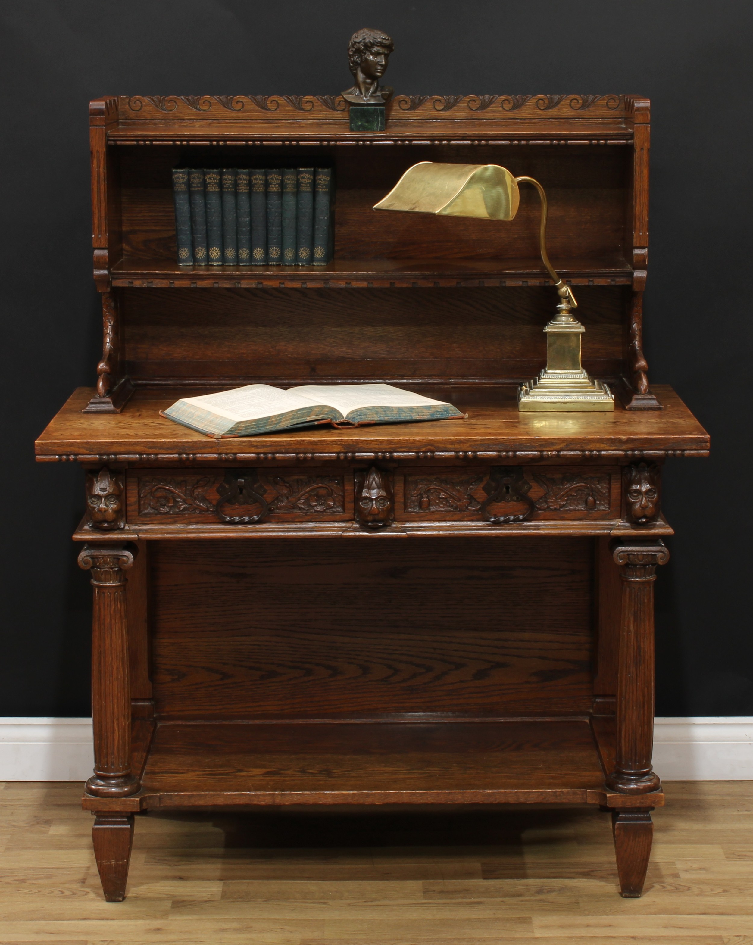 An Arts & Crafts period oak library side table, by Rasmus Nielsen, the bookcase superstructure