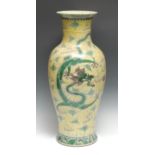 A large Chinese famille jaune porcelain inverted baluster vase, painted with ferocious dragons,