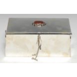 An agate mounted sterling silver spreading rectangular dressing table casket, the hinged cover