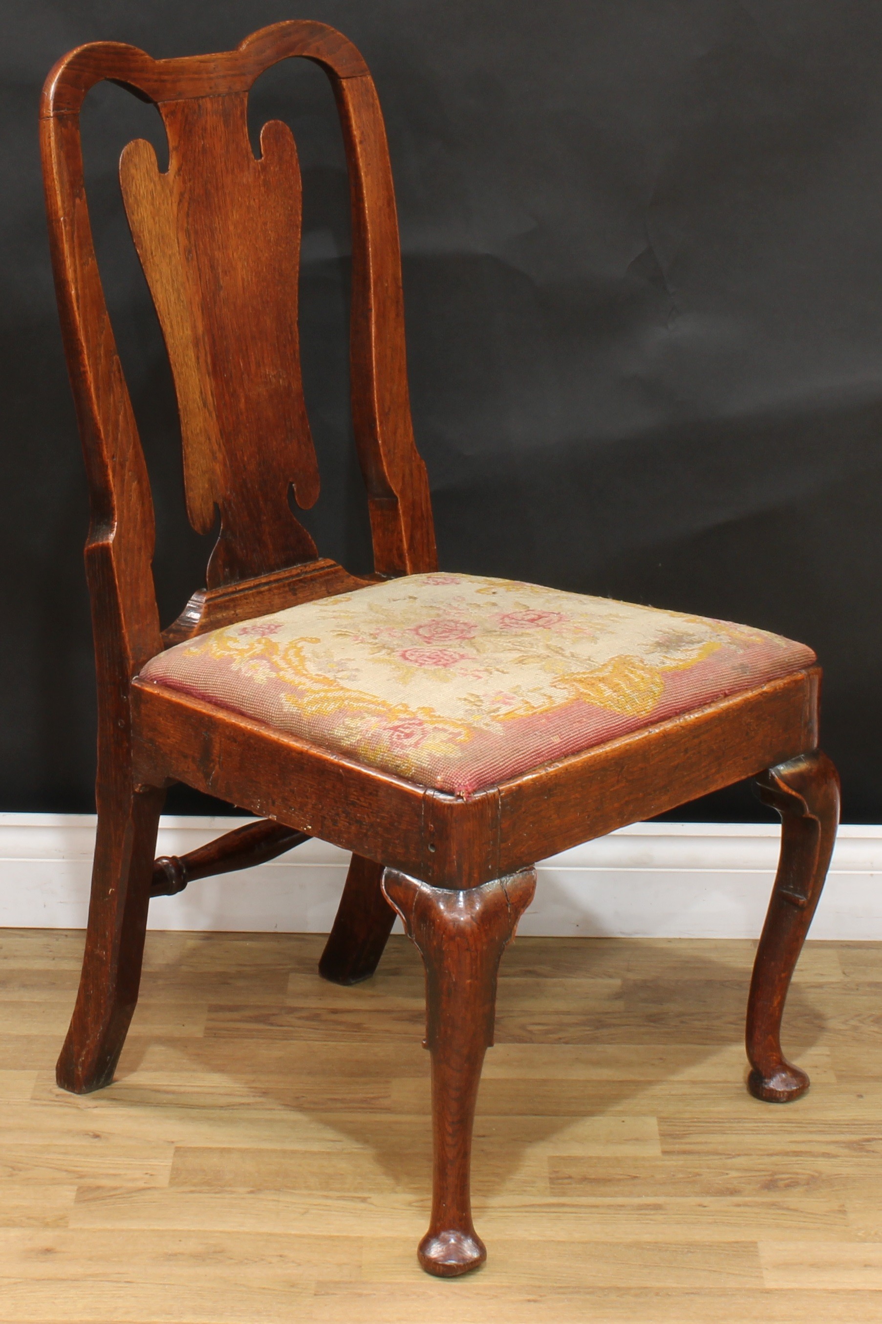 A George I oak side chair, double-arch cresting rail, vasular splat, drop-in needlework seat,