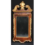 A 19th century giltwood and mahogany looking glass, in the manner of William Kent, architectural