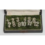 A set of twelve silver coloured metal napkin clips, numbered, 1.5cm long, early 20th century long,