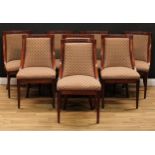 A set of eight Empire design mahogany dining chairs, curved backs carved and applied with bosses,