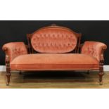 A Victorian walnut sofa, shaped arched back with leafy cresting and flanked by turned pillars,